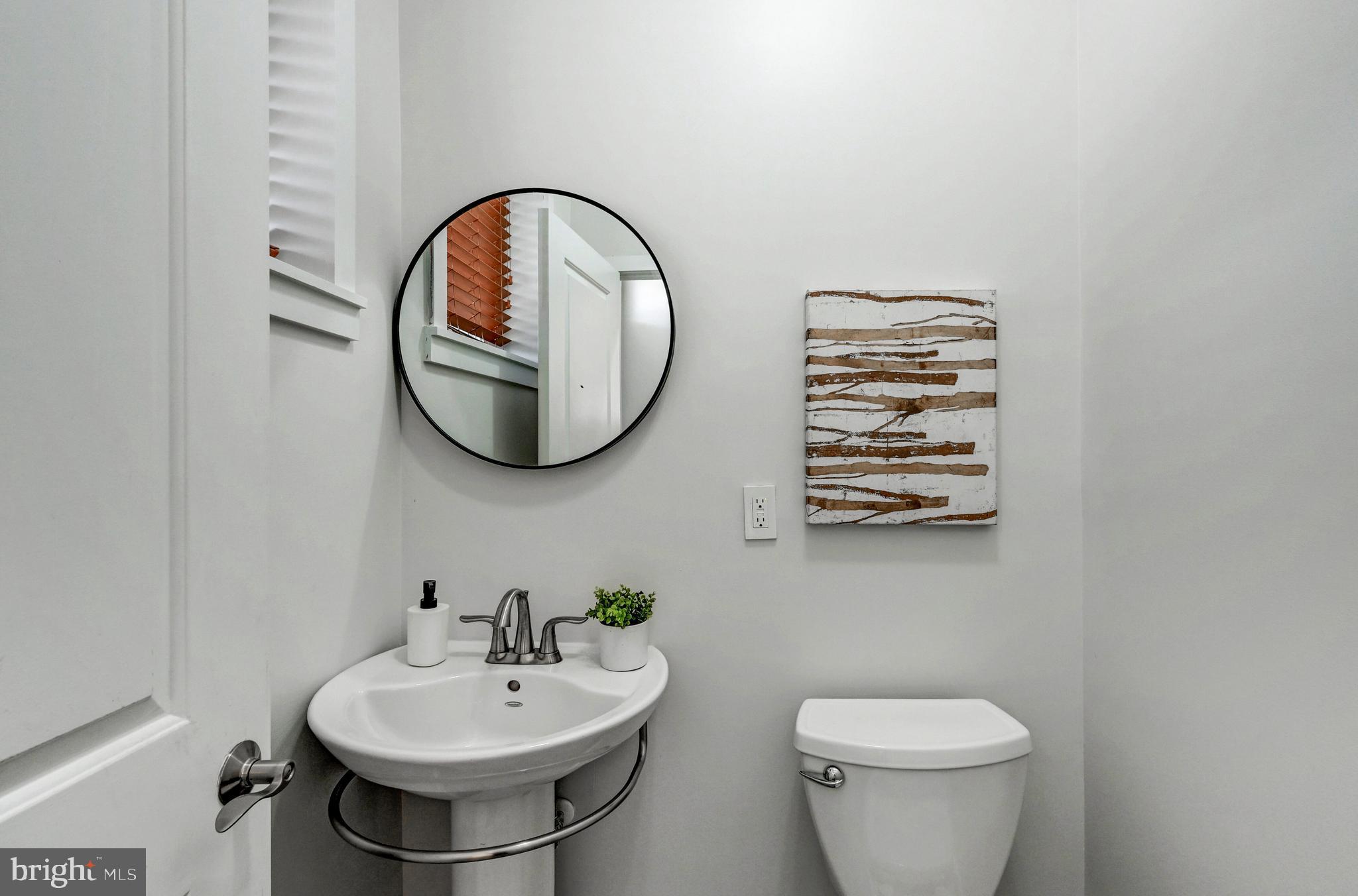 136 West Ostend Street Baltimore, MD 21230 - Photo 23 of 33 a bathroom with a sink and a mirror