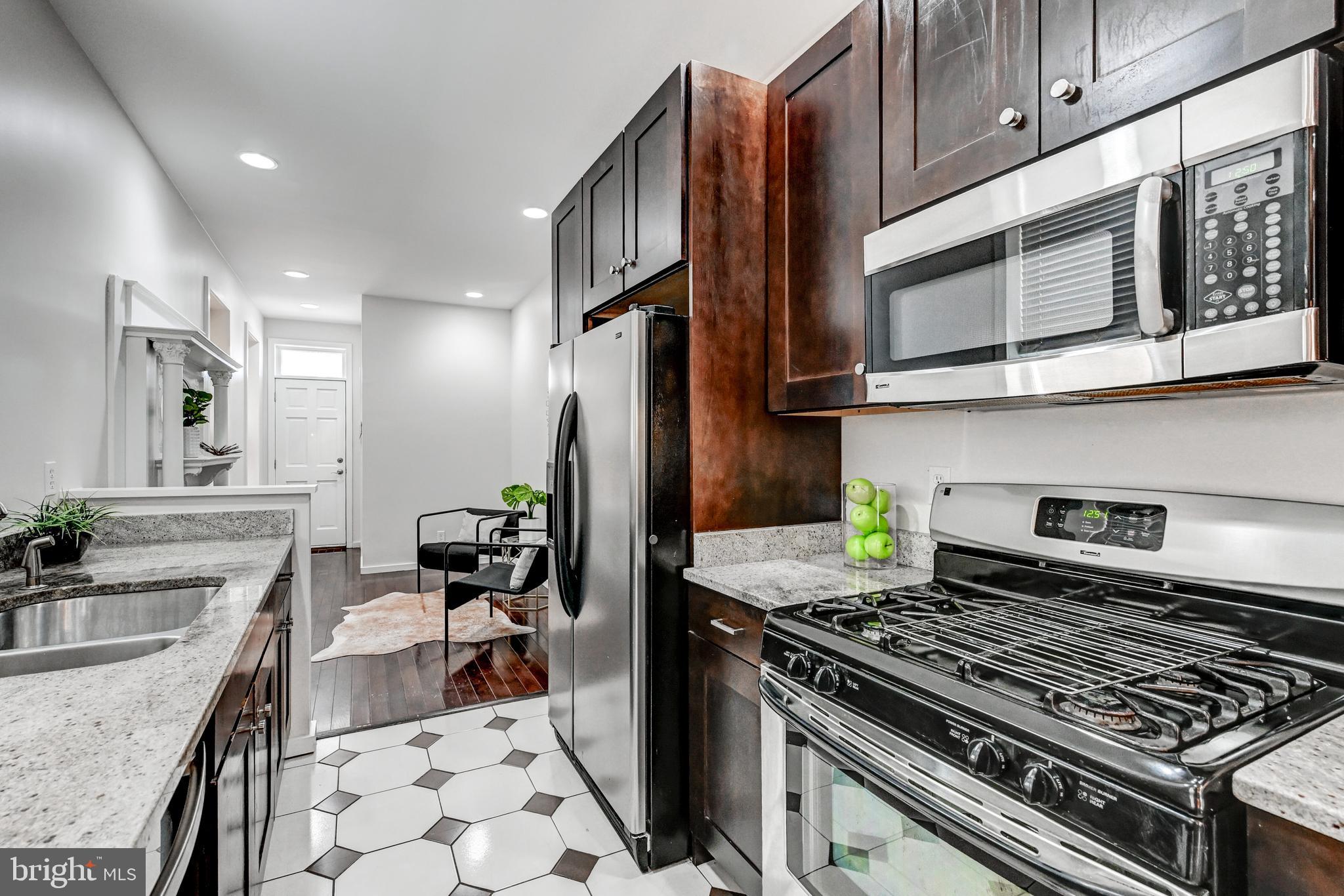 136 West Ostend Street Baltimore, MD 21230 - Photo 10 of 33 a kitchen with stainless steel appliances granite countertop a stove and a sink