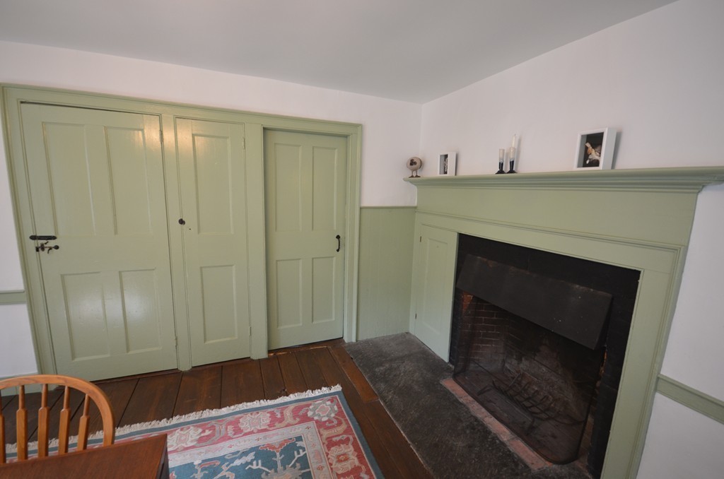 713 Bay Road Amherst, MA 01002 - Photo 13 of 29 a view of an empty room with wooden floor and a fireplace