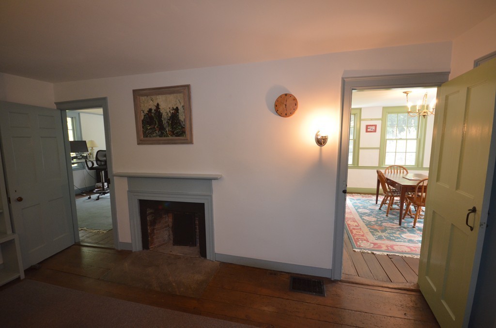 713 Bay Road Amherst, MA 01002 - Photo 16 of 29 a view of a livingroom with wooden floor and a fireplace