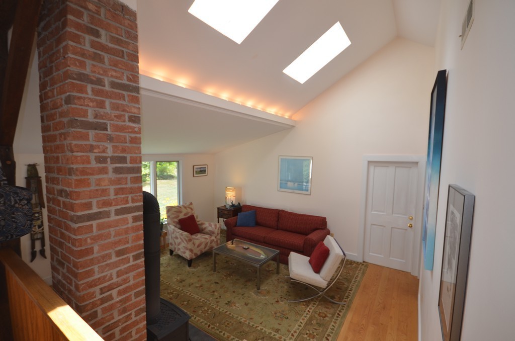 713 Bay Road Amherst, MA 01002 - Photo 3 of 29 a living room with furniture and a fireplace