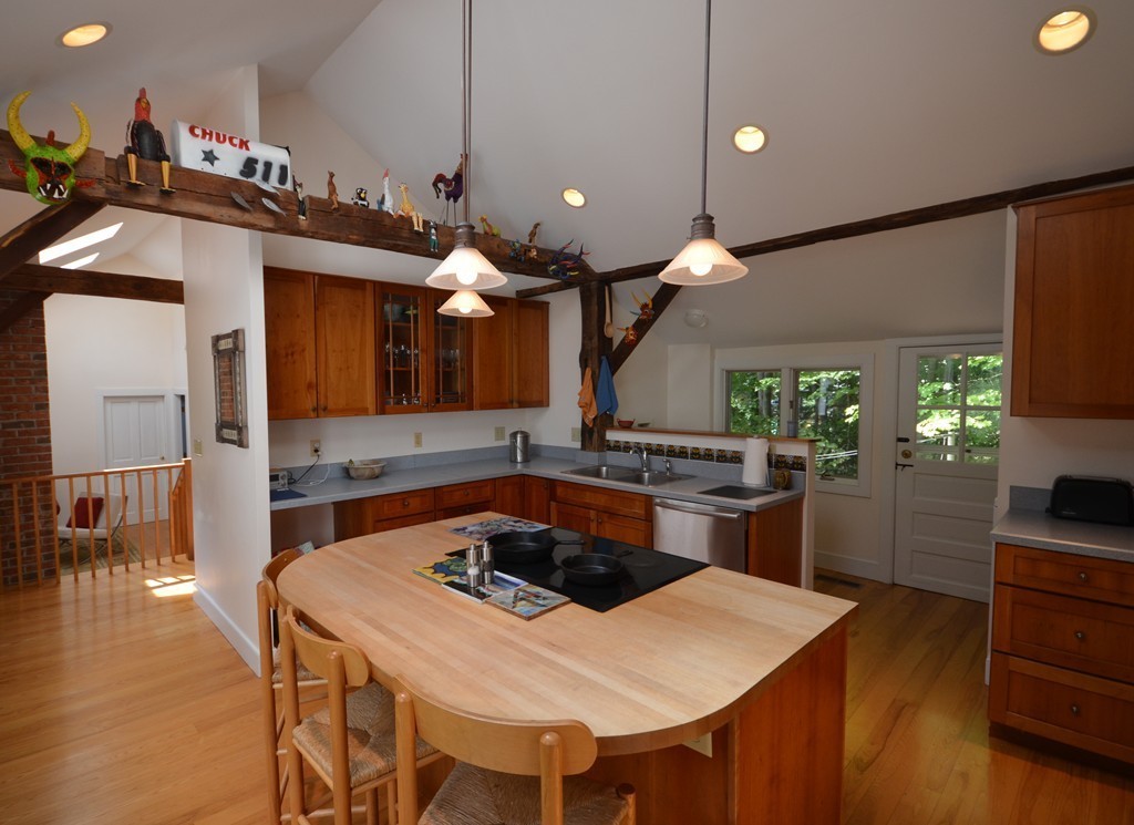 713 Bay Road Amherst, MA 01002 - Photo 8 of 29 a kitchen with a table and chairs in it