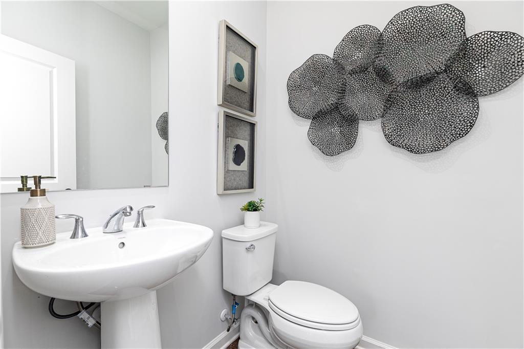 314 Skylar Court Southeast, Unit 93 Atlanta, GA 30312 - Photo 10 of 26 a bathroom with a toilet sink and mirror