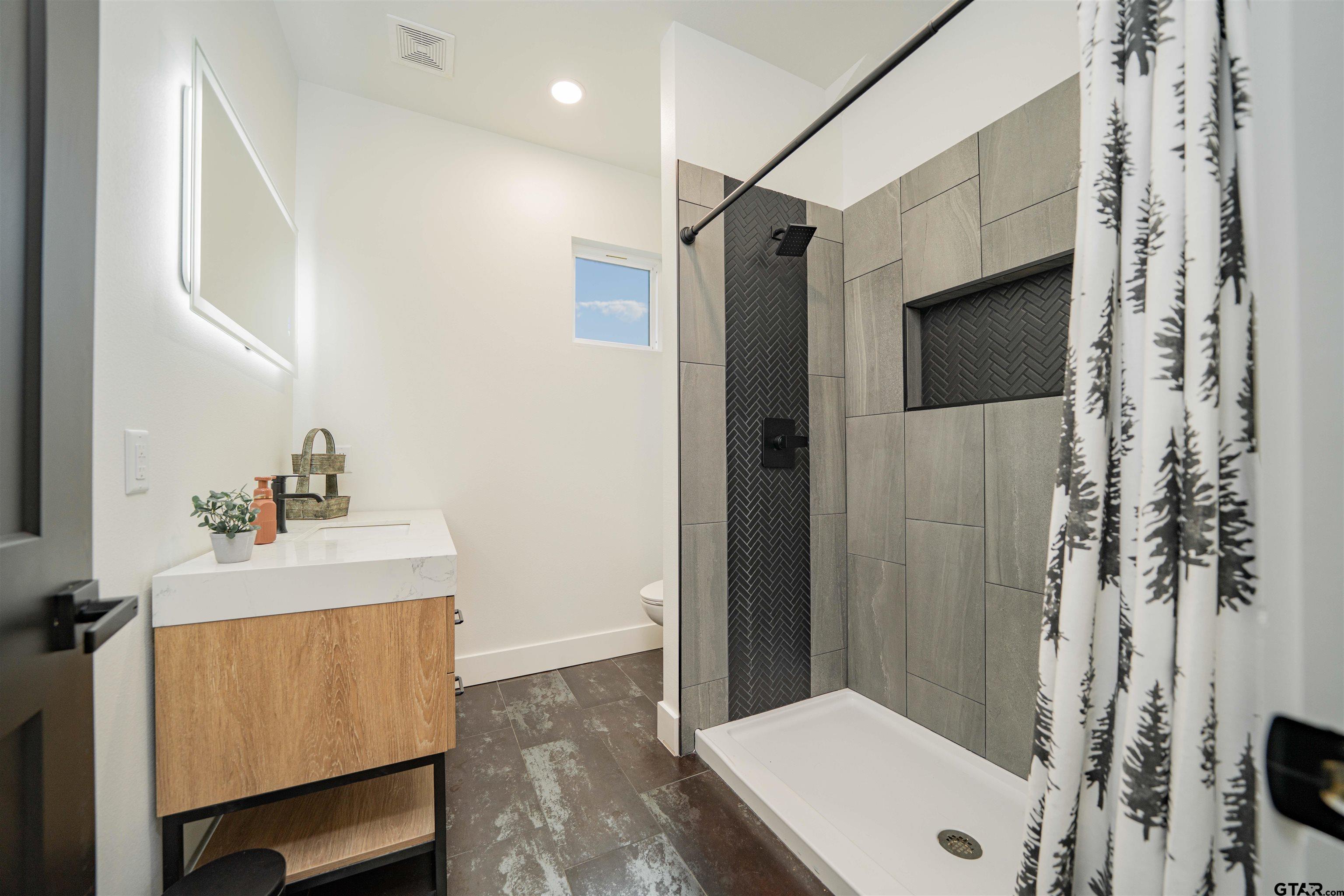 1258 Fire Tower Road Hallsville, TX 75650 - Photo 17 of 45 a bathroom with a sink toilet and shower