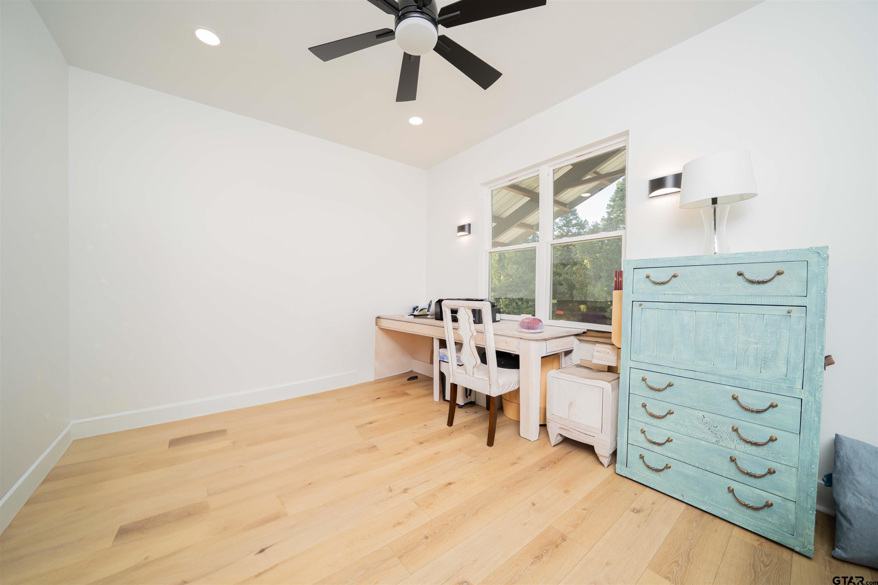 1258 Fire Tower Road Hallsville, TX 75650 - Photo 18 of 45 a view of a workspace with furniture and a window
