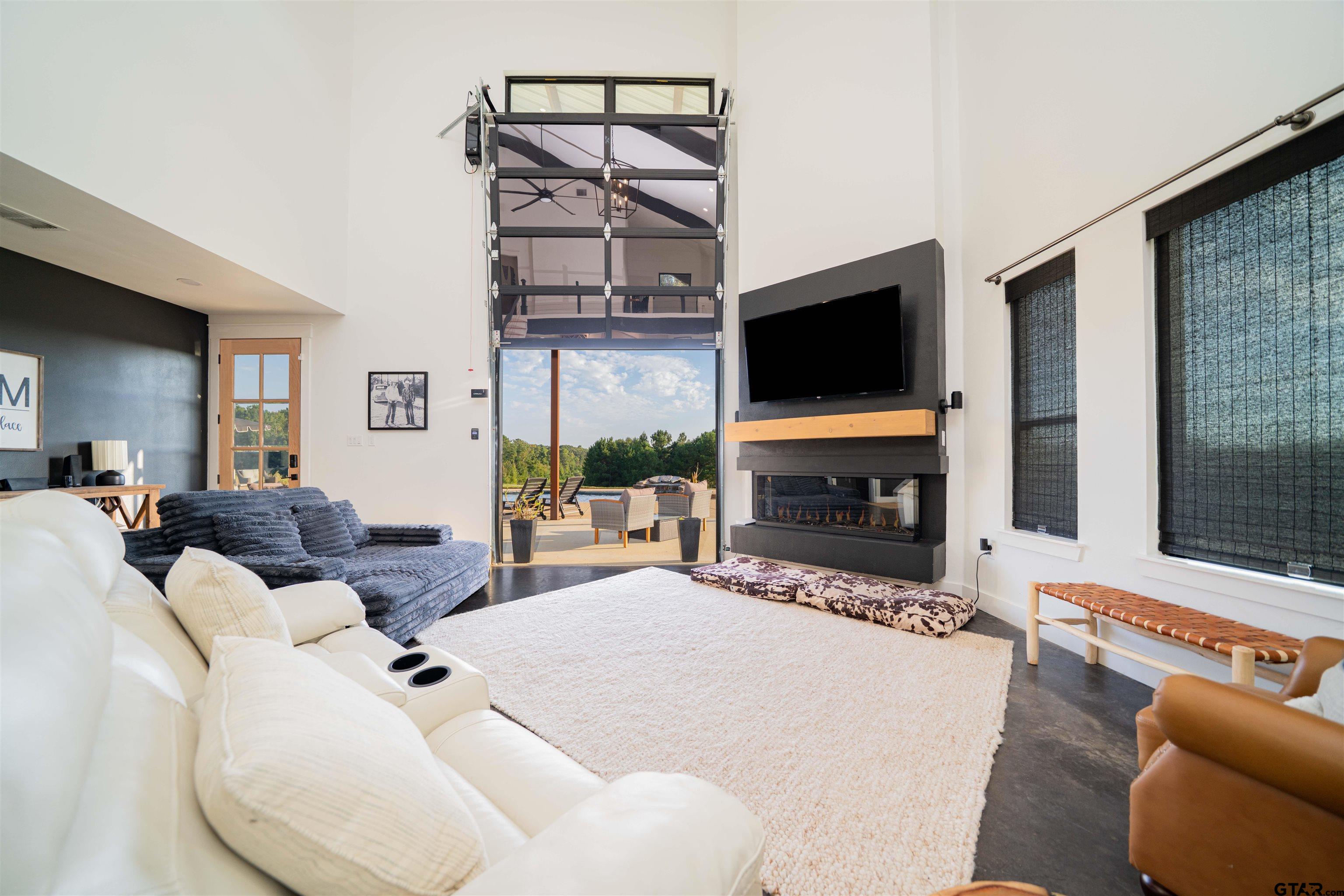 1258 Fire Tower Road Hallsville, TX 75650 - Photo 32 of 45 a living room with furniture a flat screen tv and a fireplace