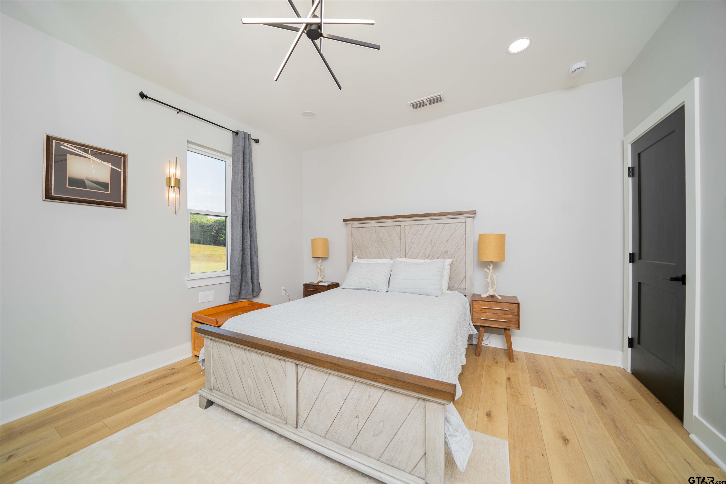 1258 Fire Tower Road Hallsville, TX 75650 - Photo 39 of 45 a bedroom with a bed and a flat screen tv