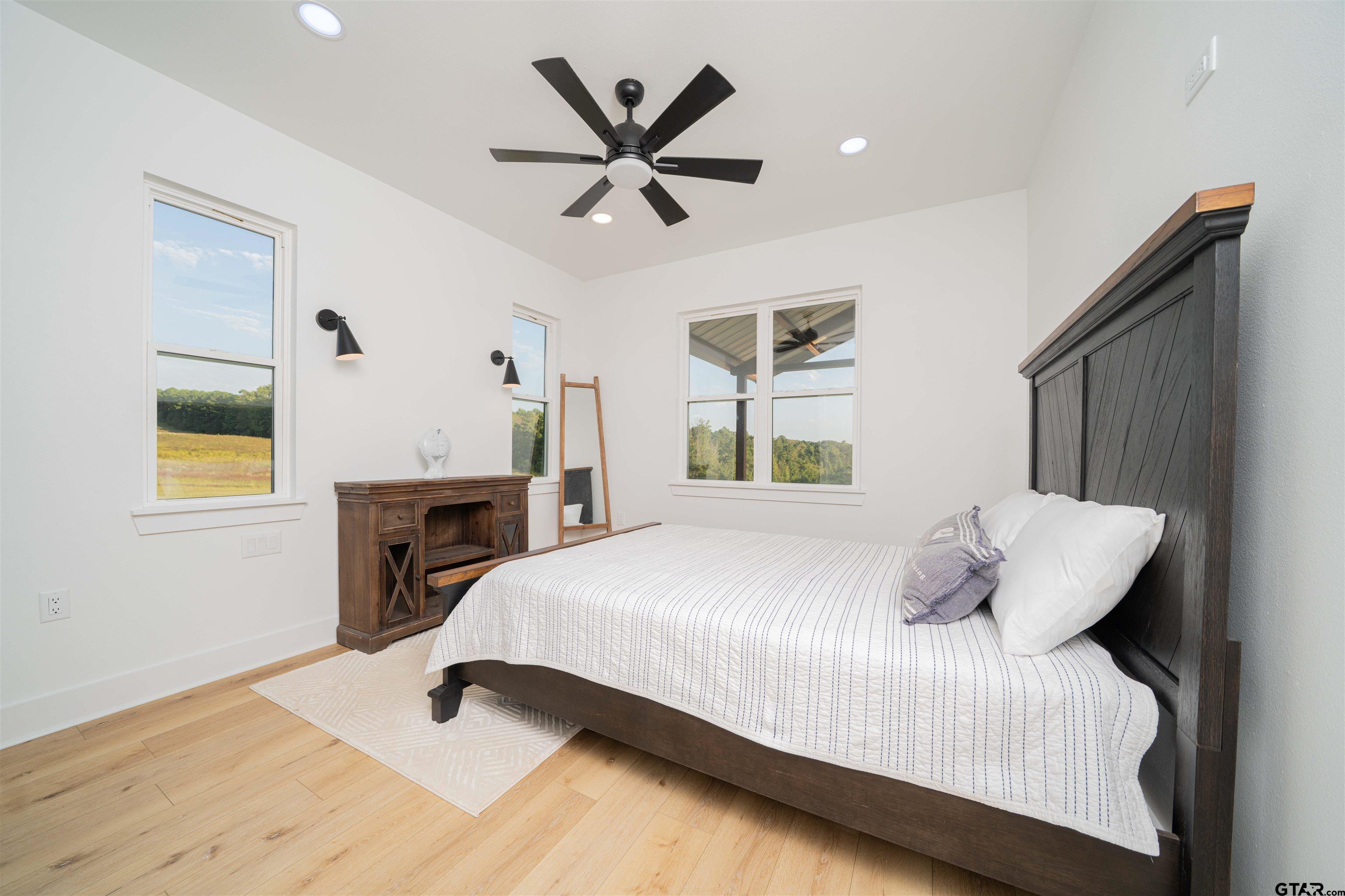 1258 Fire Tower Road Hallsville, TX 75650 - Photo 42 of 45 a bedroom with a bed and a chandelier