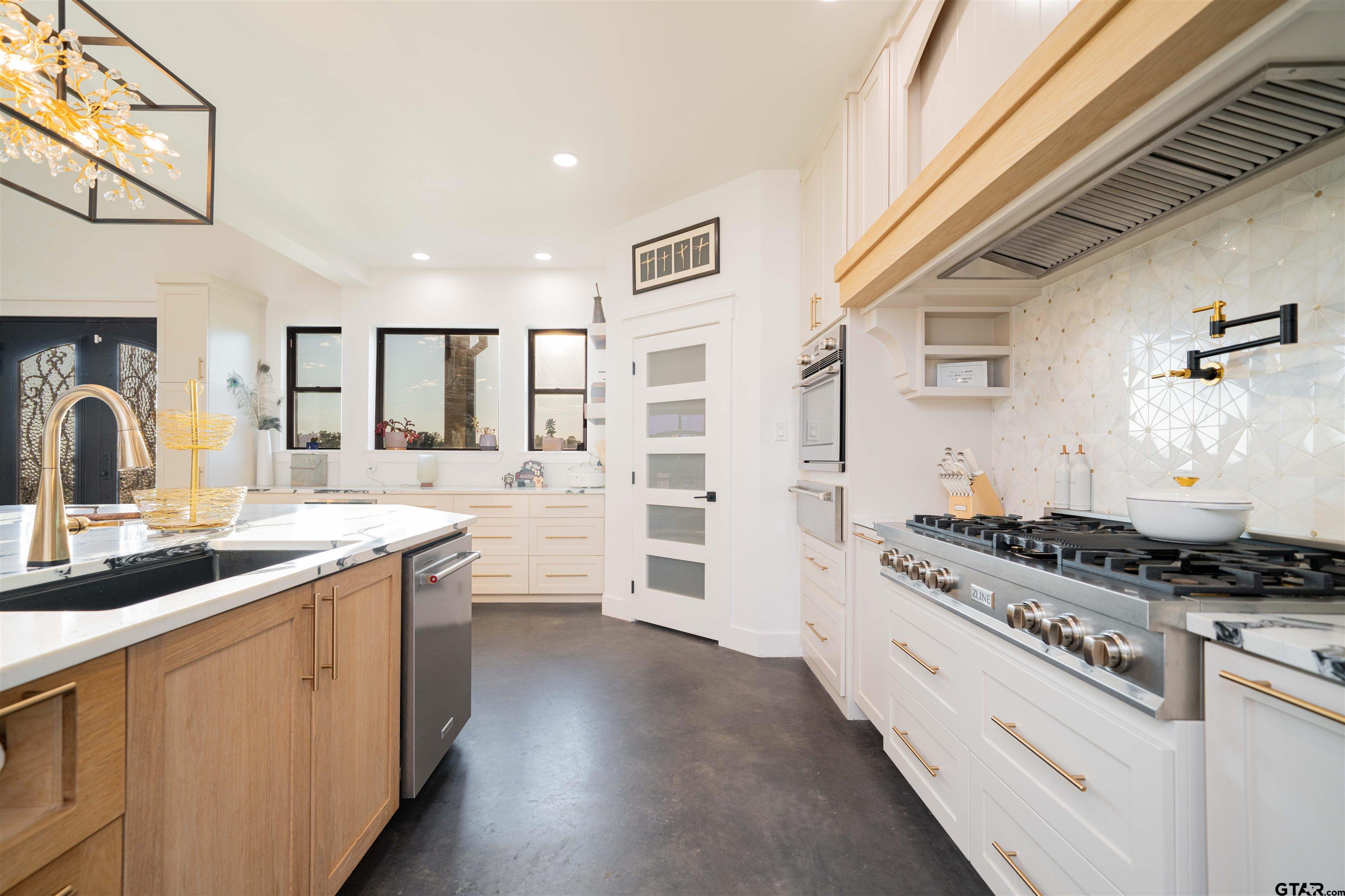1258 Fire Tower Road Hallsville, TX 75650 - Photo 6 of 45 a kitchen with stainless steel appliances a sink stove and cabinets
