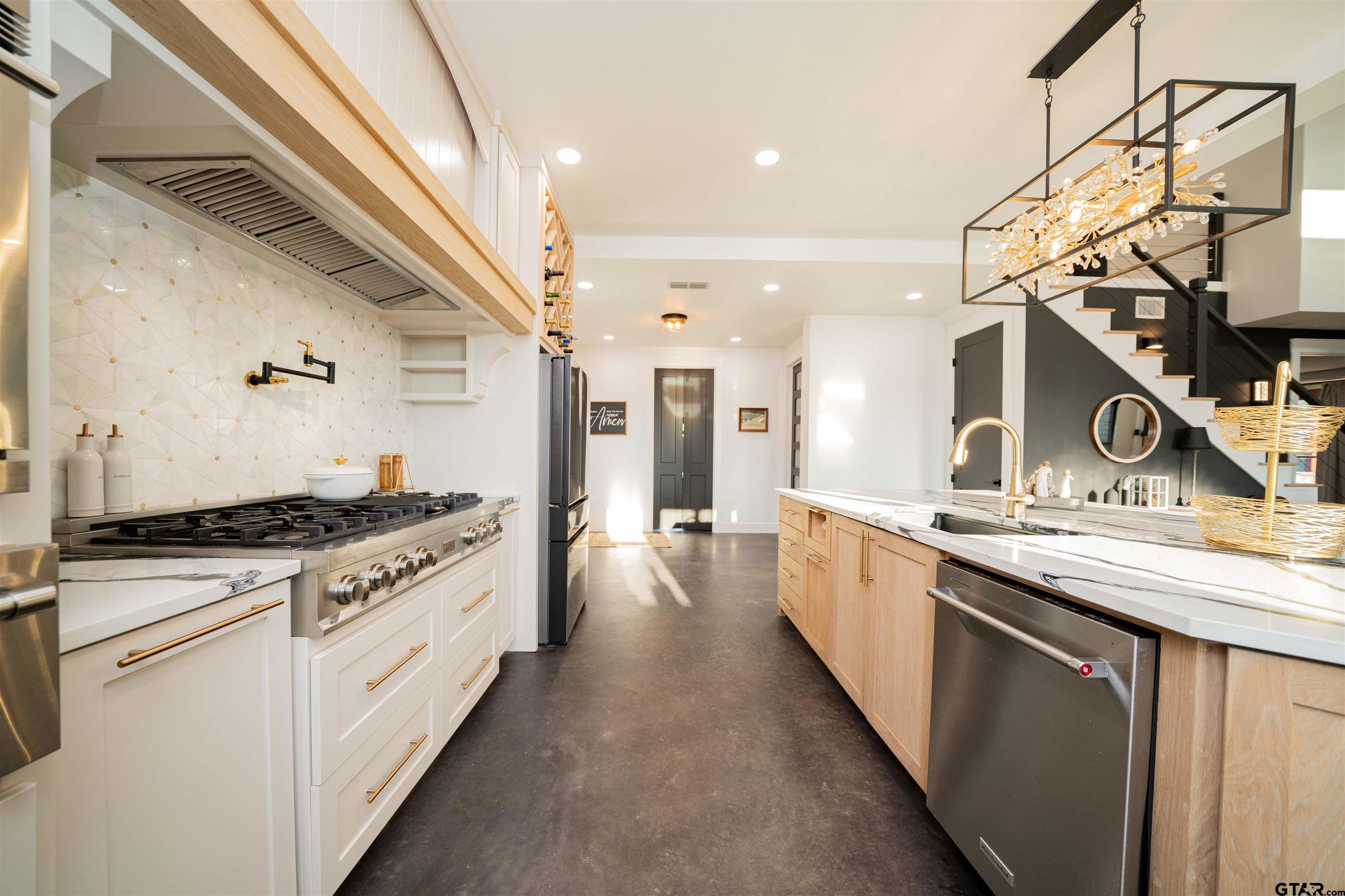 1258 Fire Tower Road Hallsville, TX 75650 - Photo 7 of 45 a large kitchen with stainless steel appliances granite countertop a stove and a sink