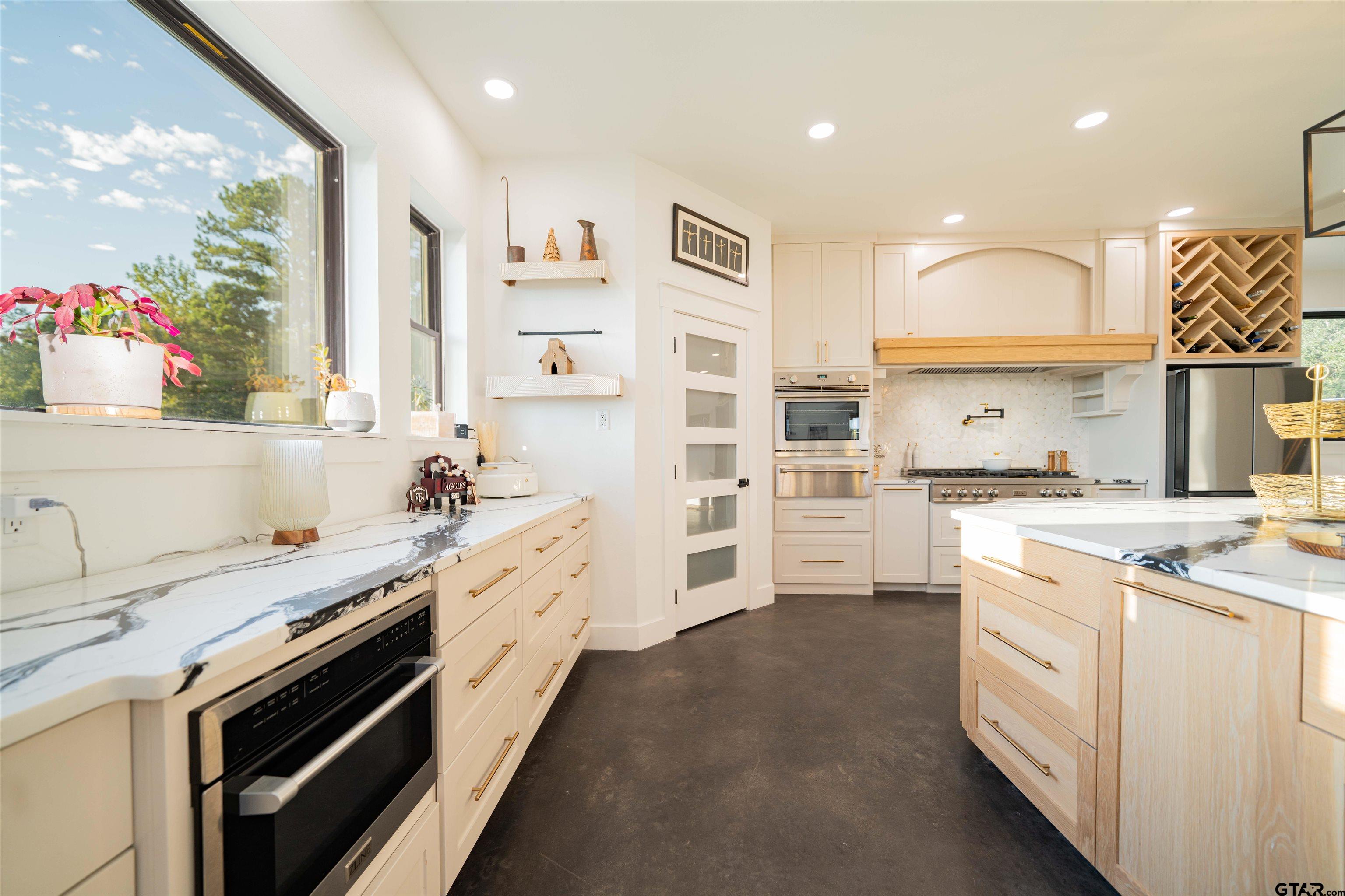 1258 Fire Tower Road Hallsville, TX 75650 - Photo 8 of 45 a kitchen with a sink stove and cabinets