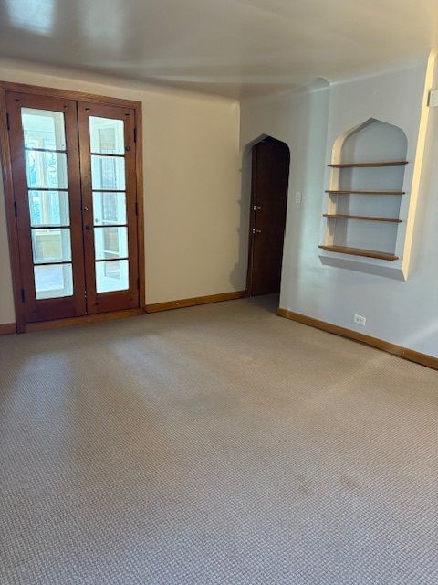 8400 South Honore Street, Unit 2 Chicago, IL 60620 - Photo 5 of 13 an empty room with windows and closet