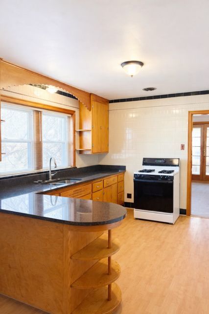 8400 South Honore Street, Unit 2 Chicago, IL 60620 - Photo 7 of 13 a view of a kitchen with a stove and a large window