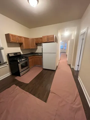 a kitchen with a stove a refrigerator and a sink
