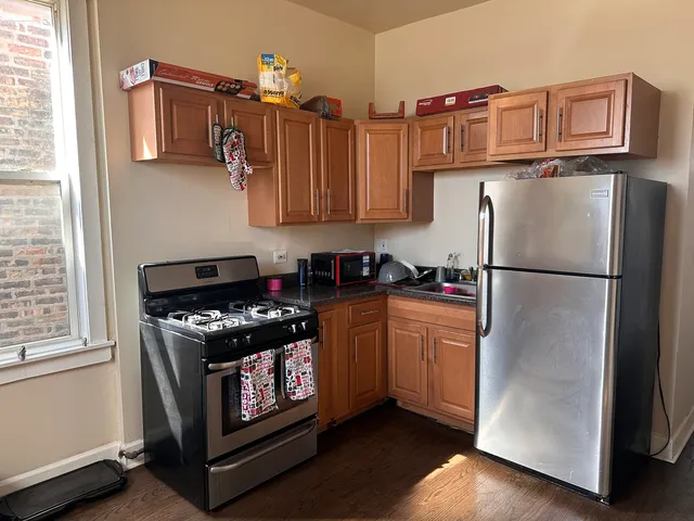 a kitchen with stainless steel appliances granite countertop a refrigerator stove a sink and dishwasher