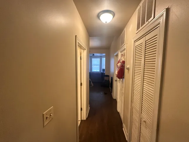 a view of a hallway with a wooden door