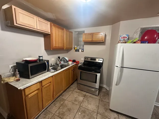 a kitchen with a refrigerator stove and microwave
