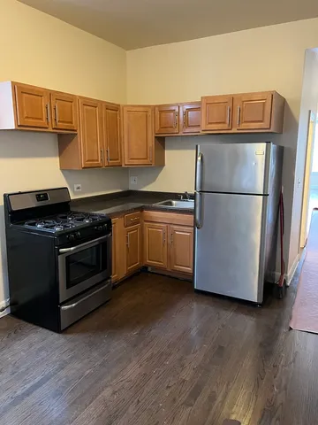a kitchen with a refrigerator and a stove