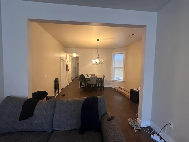 a living room with furniture and a chandelier