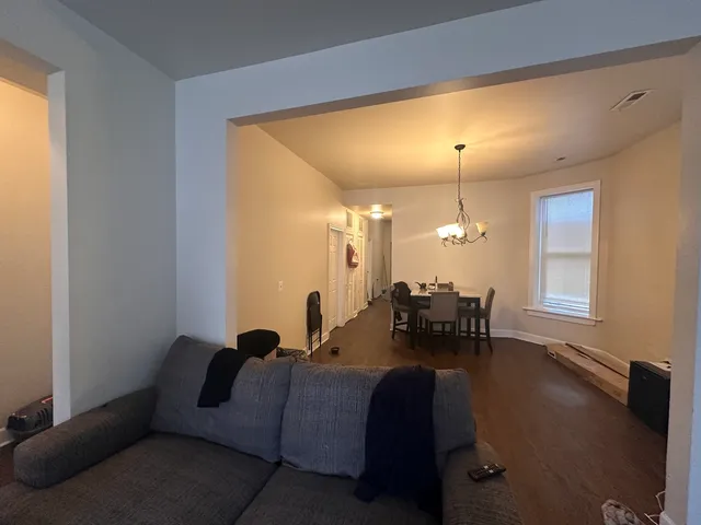 a living room with fireplace furniture and a chandelier