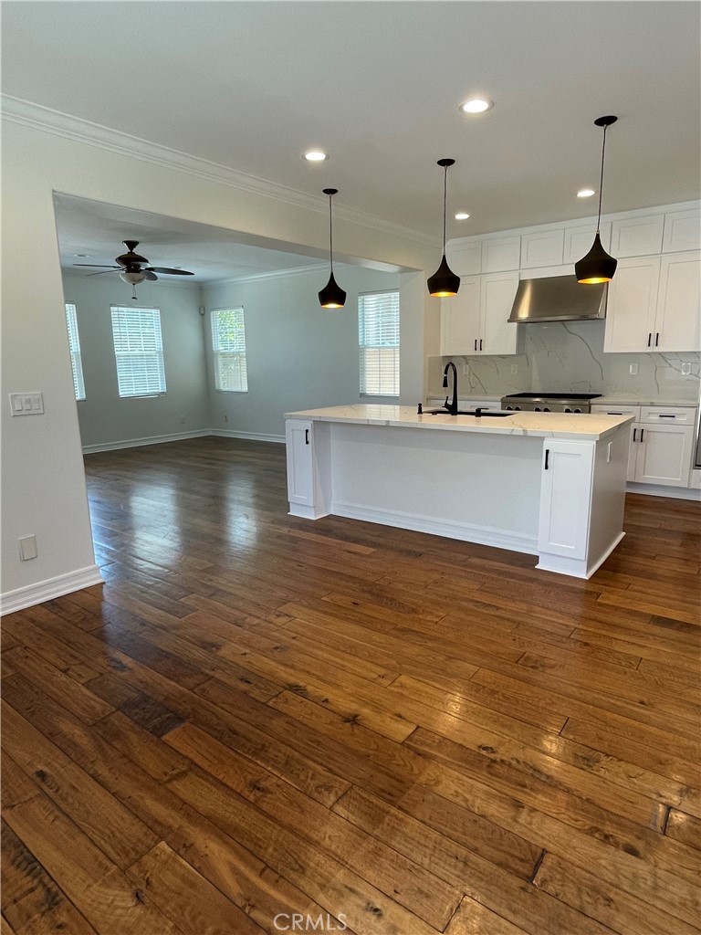 72 Downing Street Ladera Ranch, CA 92694 - Photo 2 of 14 a large kitchen with stainless steel appliances a large counter top a stove and a wooden floors