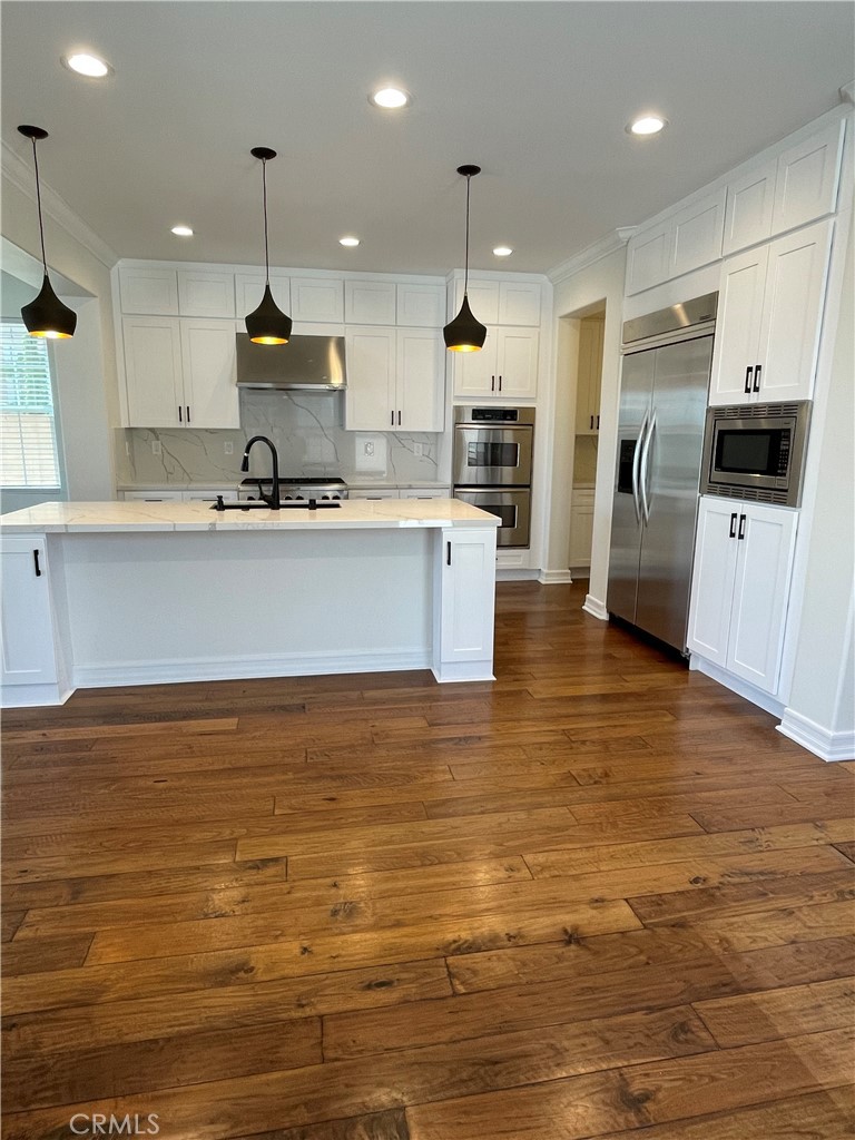 72 Downing Street Ladera Ranch, CA 92694 - Photo 3 of 14 a view of kitchen with stainless steel appliances granite countertop a sink and cabinets