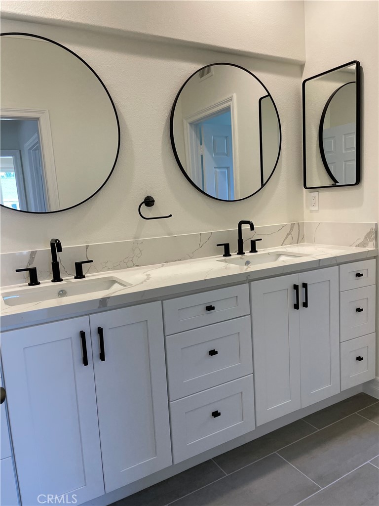 72 Downing Street Ladera Ranch, CA 92694 - Photo 7 of 14 a bathroom with a double vanity sink and a mirror