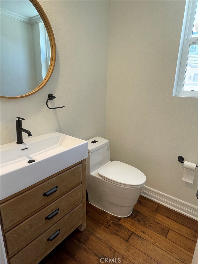 72 Downing Street Ladera Ranch, CA 92694 - Photo 8 of 14 a bathroom with a toilet and a mirror