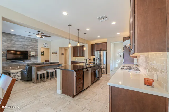 a kitchen with a sink counter top space appliances and a large window