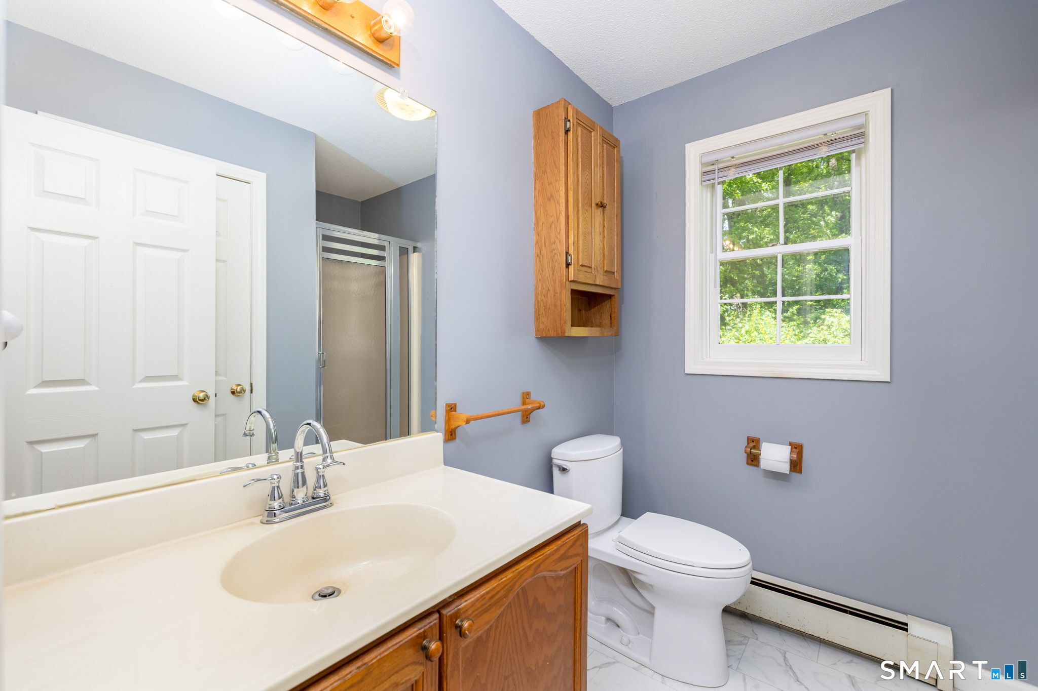 175 Vernon Street Manchester, CT 06042 - Photo 16 of 38 a bathroom with a sink a toilet and a mirror