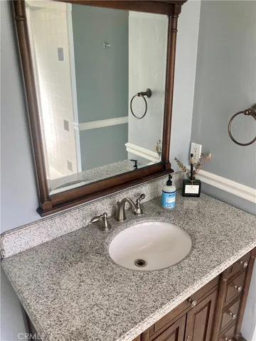 a view of a bench in backyard of the house