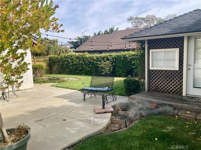 a view of a bench with potted plants and a fountain