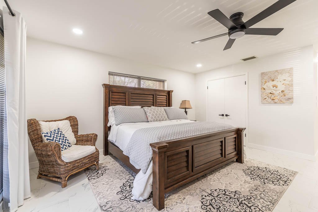 4760 Greentree Way, Unit A Boynton Beach, FL 33436 - Photo 16 of 30 a bedroom with a bed and a couch