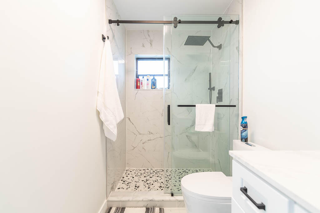 4760 Greentree Way, Unit A Boynton Beach, FL 33436 - Photo 18 of 30 a bathroom with a shower and a toilet
