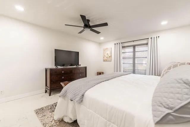 a bedroom with a bed and a flat screen tv