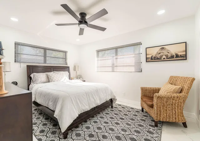 a bedroom with a bed and chair