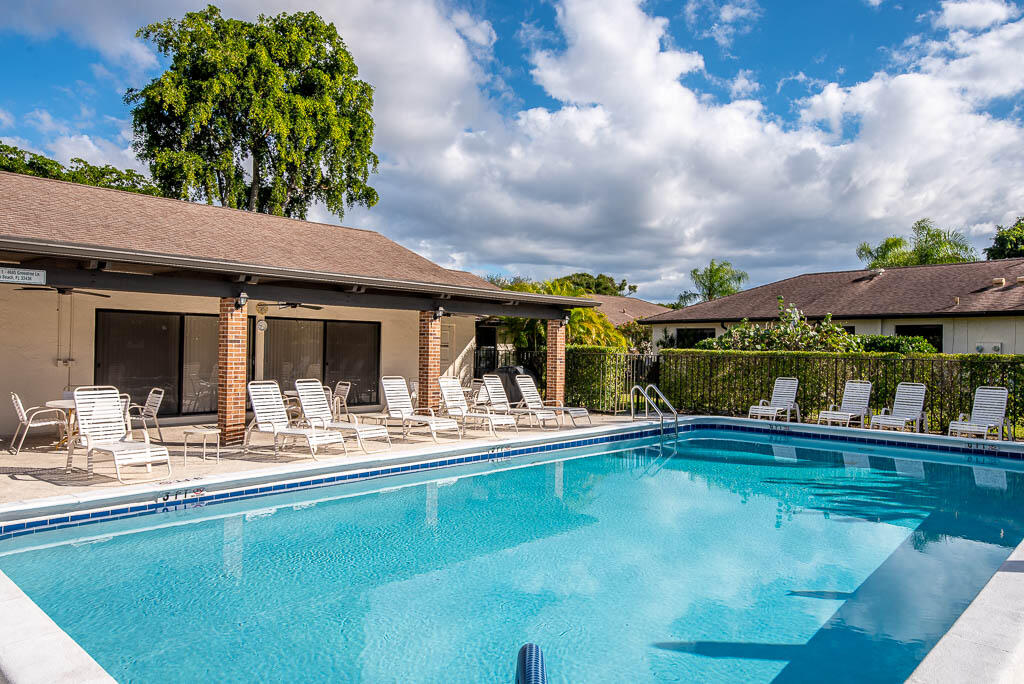 4760 Greentree Way, Unit A Boynton Beach, FL 33436 - Photo 2 of 30 a view of house with swimming pool and outdoor seating