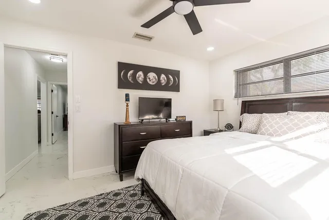 a bedroom with a bed and cabinets