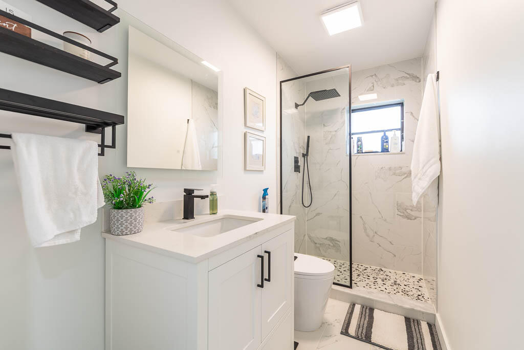 4760 Greentree Way, Unit A Boynton Beach, FL 33436 - Photo 23 of 30 a bathroom with a sink a toilet and shower