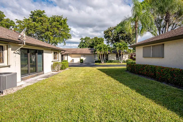 a view of house with outdoor space and garden