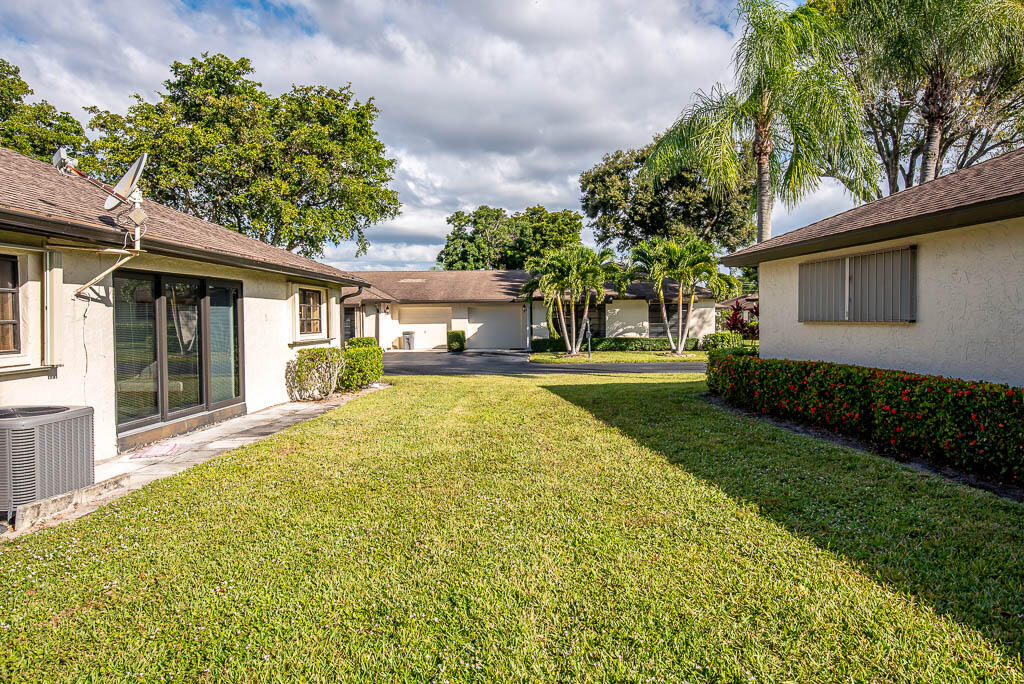 4760 Greentree Way, Unit A Boynton Beach, FL 33436 - Photo 24 of 30 a view of house with outdoor space and garden