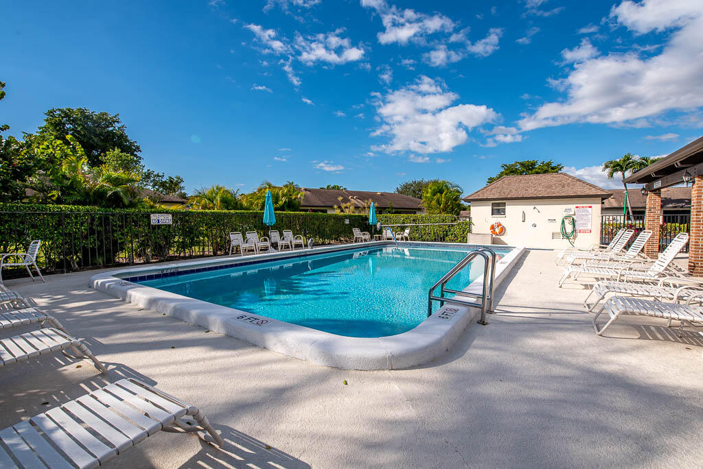 4760 Greentree Way, Unit A Boynton Beach, FL 33436 - Photo 27 of 30 a view of a swimming pool with a patio
