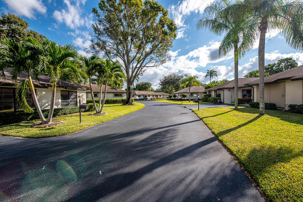 4760 Greentree Way, Unit A Boynton Beach, FL 33436 - Photo 28 of 30 a view of a swimming pool with an outdoor seating