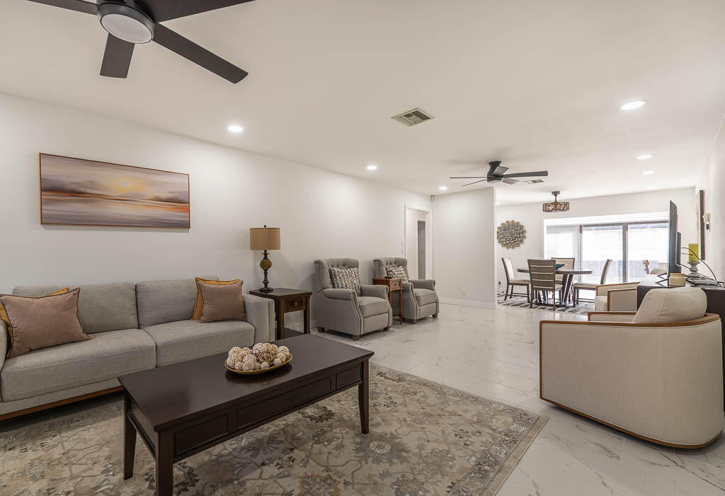 4760 Greentree Way, Unit A Boynton Beach, FL 33436 - Photo 3 of 30 a living room with furniture and a view of kitchen