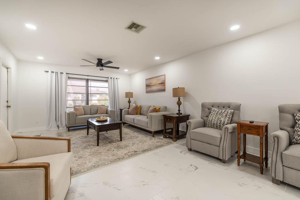 4760 Greentree Way, Unit A Boynton Beach, FL 33436 - Photo 5 of 30 a living room with furniture and a large window