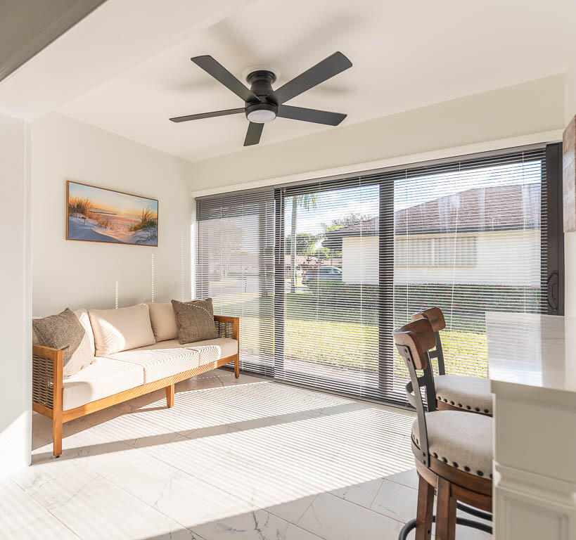 4760 Greentree Way, Unit A Boynton Beach, FL 33436 - Photo 8 of 30 a living room with furniture and a large window