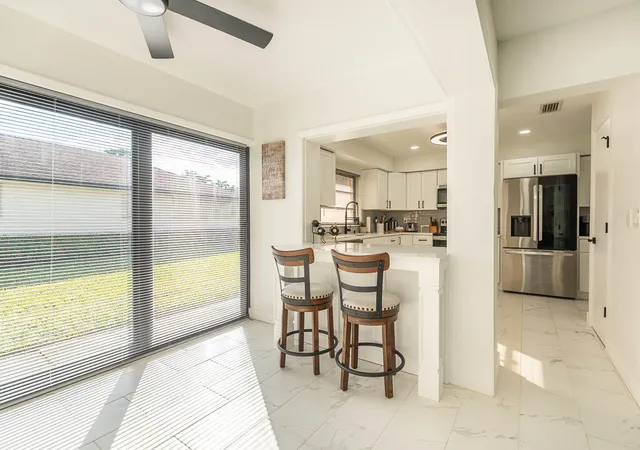 a kitchen with a dining table chairs and chandelier