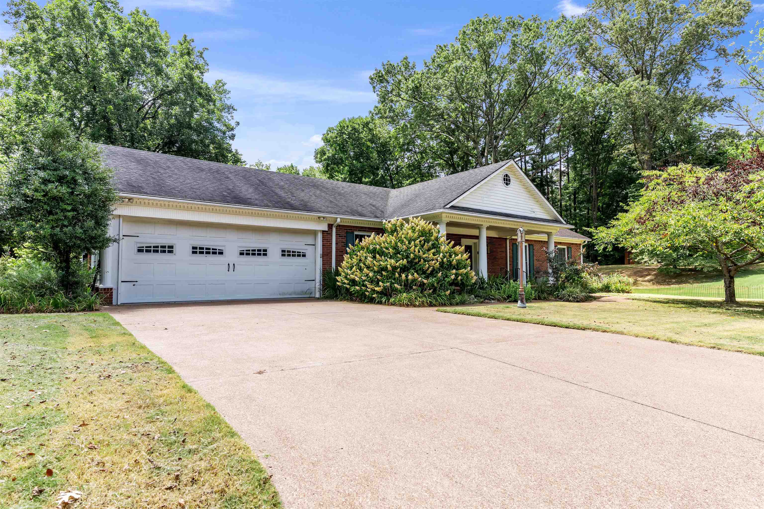 a front view of house with yard and trees
