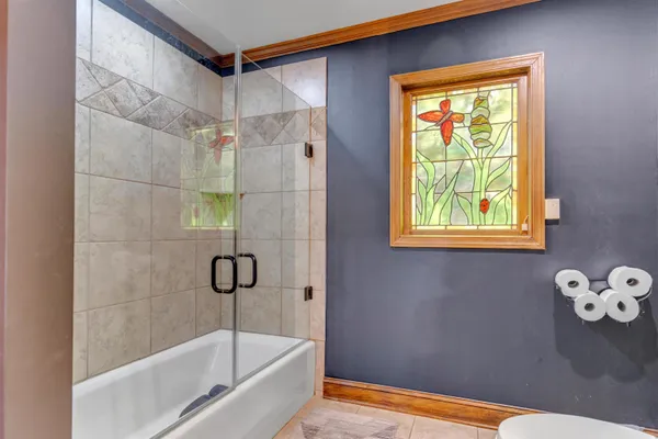 a bathroom with a granite countertop sink mirror vanity and toilet