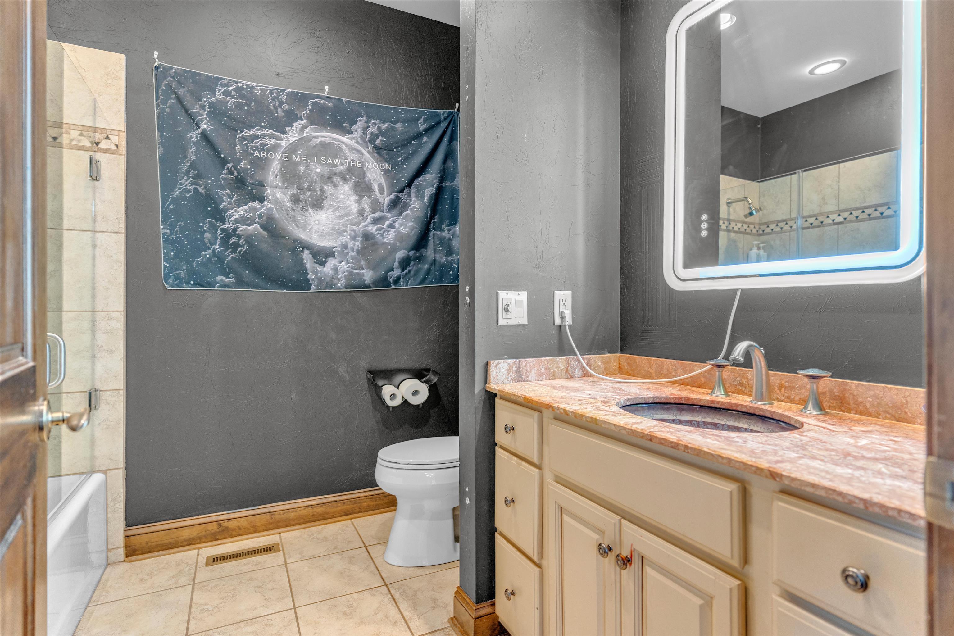 115 Westwood Cove Ripley, TN 38063 - Photo 28 of 40 a bathroom with a granite countertop sink mirror vanity and toilet